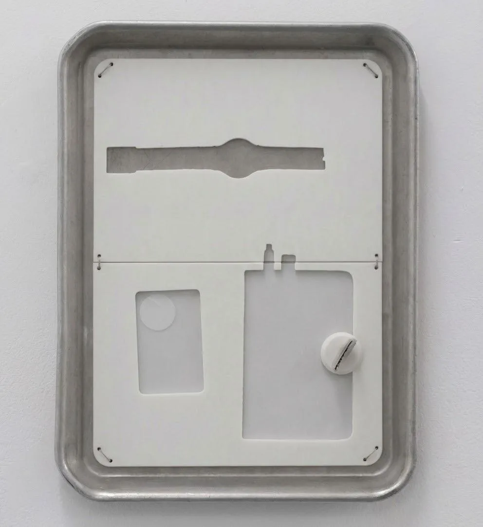 Entrance Tray detail: the upper half of a worn, cut-in-half Personal Reminder